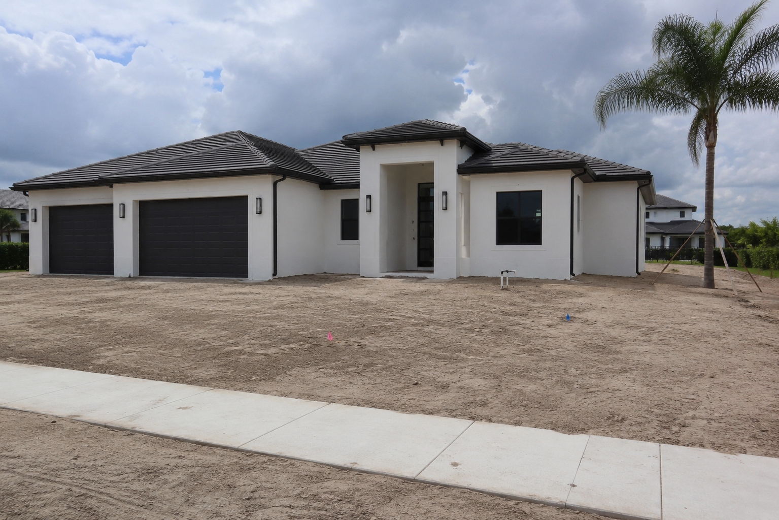 Builder-grade home with bare dirt before landscaping